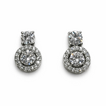 Load image into Gallery viewer, Pair of silver earrings with clear gemstones on a white background
