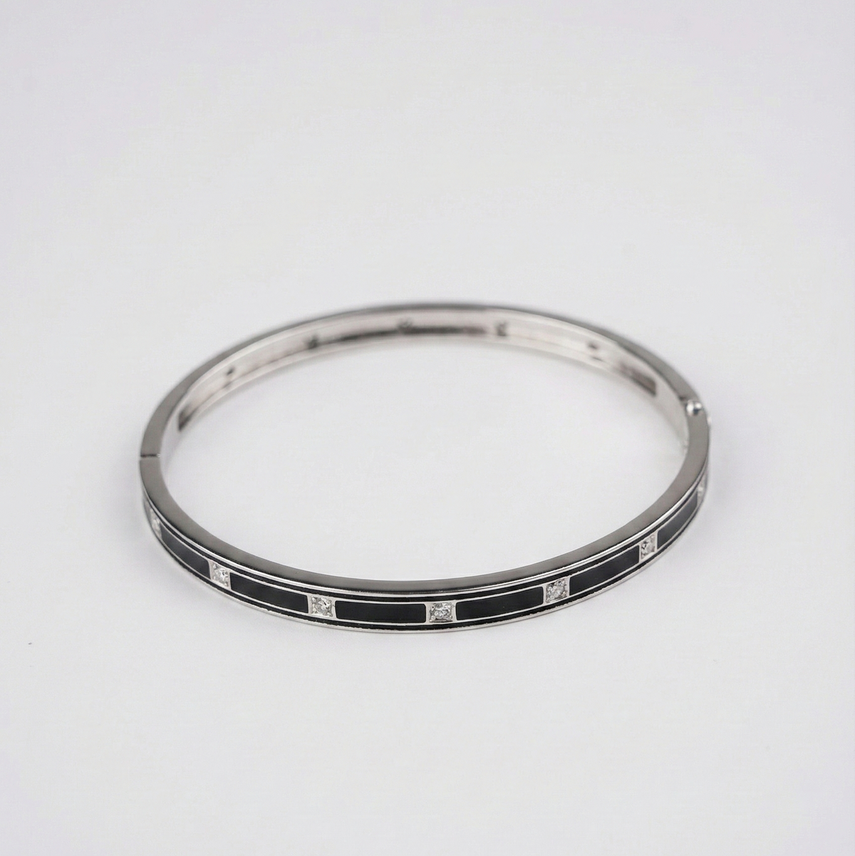 Silver bracelet with black and white pattern on a white background